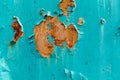 Brown rust with peeling blue paint on old fence Royalty Free Stock Photo