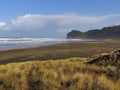 Brown Sand Beach with Wide Dune. Windy Suny Day. Mountains in the Background. Royalty Free Stock Photo