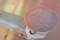 Brown sandpaper Closeup polishing machine Old round sandpaper. On a wooden table. Light