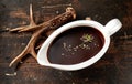 Brown sauce in gravy boat near antler