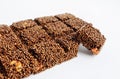 Brown sesame seed honey bars on white backgrouns.