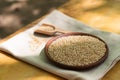 Brown sesame seeds in a clay bowl on a wooden table. Royalty Free Stock Photo