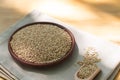 Brown sesame seeds in a clay bowl on a wooden table. Royalty Free Stock Photo