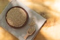 Brown sesame seeds in a clay bowl on a wooden table. Royalty Free Stock Photo