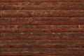 Brown shabby wooden planks. Surface of a wooden decrepit fence. Dilapidated oak planking. Texture of old brown boards. Grunge wood Royalty Free Stock Photo