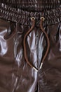 Brown faux leather elasticated waist drawstring jogger trousers close-up