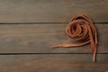Brown shoelaces on wooden background, top view. Space for text Royalty Free Stock Photo