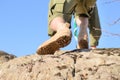 Brown Shoes of a Boy Scout Climbing a Rock