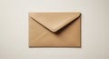 A brown, A4-sized envelope made of kraft paper lies on a light, textured surface. The Royalty Free Stock Photo