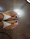 Brown skinned feet with purple toes Royalty Free Stock Photo