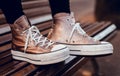 Brown slippers with white laces on wooden chair Royalty Free Stock Photo