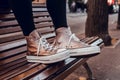 Brown slippers with white laces on wooden chair Royalty Free Stock Photo