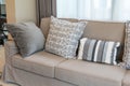 Brown sofa with grey patterned pillows