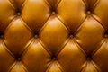 The brown soft leatherette background with asymmetrical buttons. Soft and expensive furniture elements. Luxury background Royalty Free Stock Photo