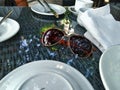 Brown spectacles on the table surrounded by white plates, cup and serbs Royalty Free Stock Photo