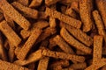 Brown spicy rye croutons sticks as background. Pieces of dry bread, top view. Royalty Free Stock Photo