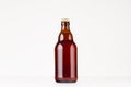 Brown steinie belgian beer bottle 330ml mock up. Template for advertising, design, branding identity on white wood table.