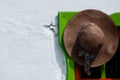 Brown straw hat hanging on colorful doorway