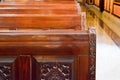 Strong beautiful wooden benches, seats in the church with carved patterns for prayers.