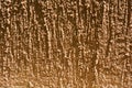 Brown structural street plaster, bark beetle building paint for outdoor decoration in sunlight. Royalty Free Stock Photo