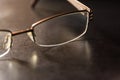 Brown Stylish Reading Glasses Setting on Black Desktop Workspace