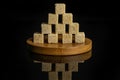 Brown sugar cube isolated on black glass Royalty Free Stock Photo