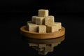 Brown sugar cube isolated on black glass Royalty Free Stock Photo