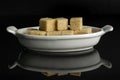 Brown sugar cube isolated on black glass Royalty Free Stock Photo