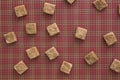 Brown sugar cubes pattern background. Top view. Diet unhealty sweet addiction concept