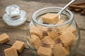 Brown sugar cubes in spoon on jar Royalty Free Stock Photo