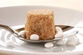 Brown sugar lump and artificial sweetener Royalty Free Stock Photo