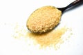 Brown sugar in a spoon on white background Royalty Free Stock Photo