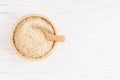 Brown sugar and wood spoon in brown bowl on white wooden table, top view and copy space Royalty Free Stock Photo