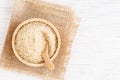 Brown sugar and wood spoon in brown bowl on white wooden table, top view and copy space Royalty Free Stock Photo