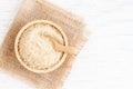 Brown sugar and wood spoon in brown bowl on white wooden table, top view and copy space Royalty Free Stock Photo