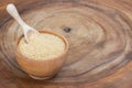 brown sugar in wooden bowl with scoop isolated on wood Royalty Free Stock Photo