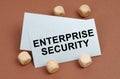 On a brown surface, wooden cubes and a business card with the inscription - Enterprise Security