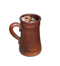 Brown Syrian hamster crawls into a large earthenware beer mug