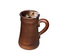 Brown Syrian hamster crawls into a large earthenware beer mug