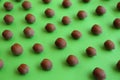 Brown tasty hazelnuts on green background, closeup