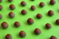Brown tasty hazelnuts on green background, closeup