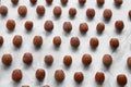 Brown tasty hazelnuts on light marble table