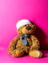 Brown teddy bear with bandage at the head at pediatrician Royalty Free Stock Photo