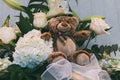 Brown teddy bear between a flowers bouquet Royalty Free Stock Photo