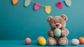 Brown Teddy Bear Holding Decorated Easter Eggs on Teal Background Royalty Free Stock Photo