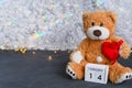 brown teddy bear. red heart and wooden calendar Valentine's Day - February 14.