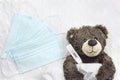 Brown teddy bear with a thermometer tablets and a medical mask Royalty Free Stock Photo