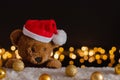 Brown teddy bear wearing santa claus hat with Christmas ornaments Royalty Free Stock Photo