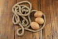 Brown three egg in a nest of twine for Happy Easter Royalty Free Stock Photo