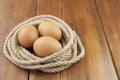 Brown three egg in a nest of twine for Happy Easter Royalty Free Stock Photo